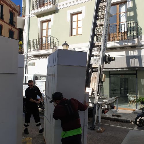 Operarios moviendo los muebles embalados